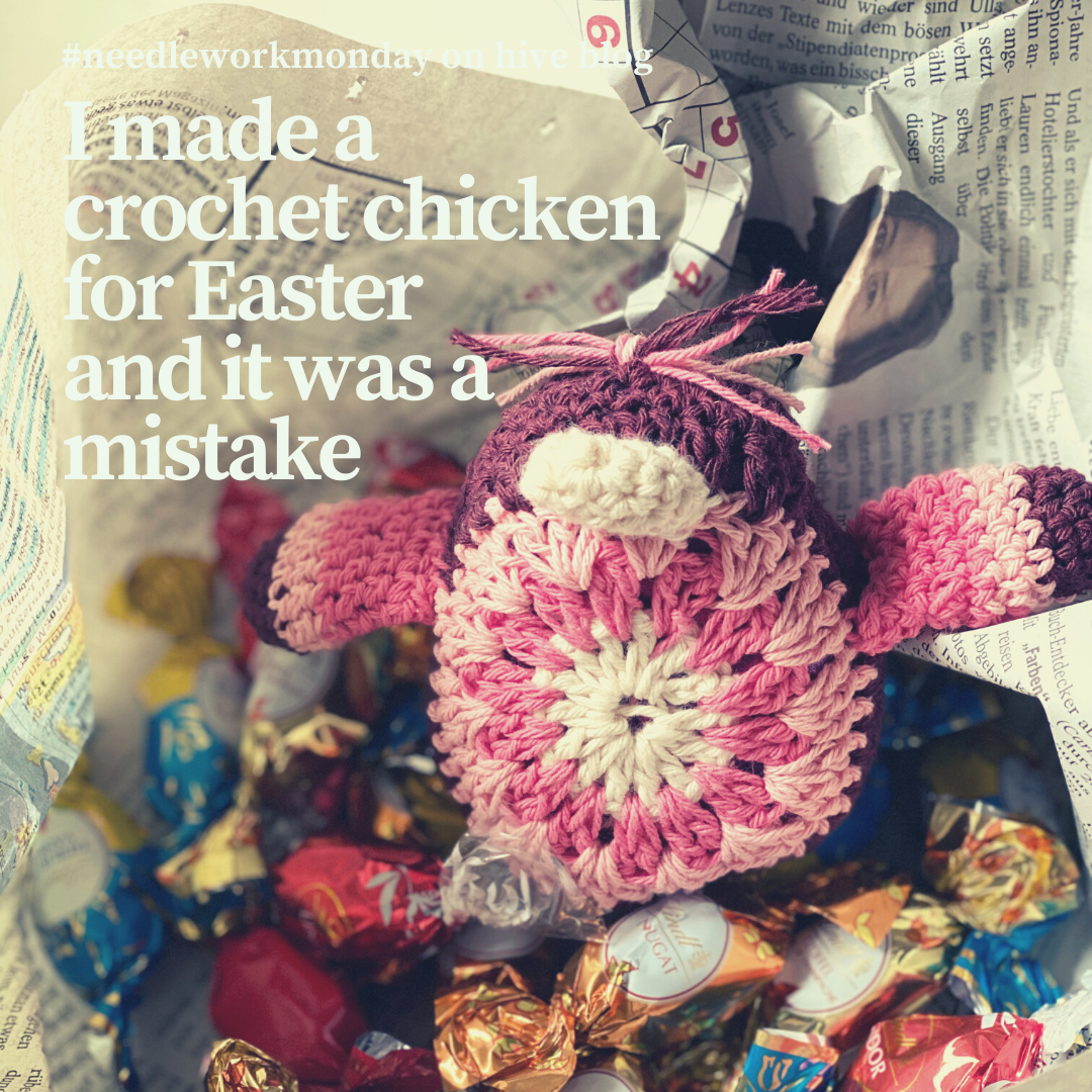 an open present with chocolate eggs and a crochet chicken decoration for Easter