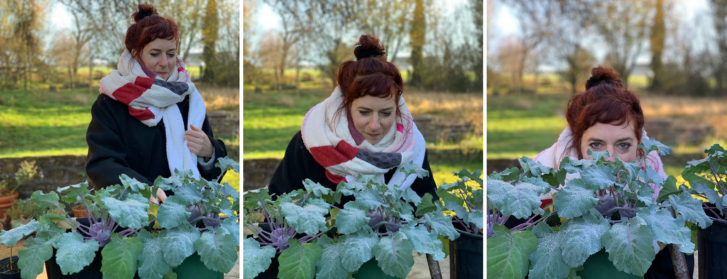 Simone wearing her handmade shawl outside in a garden in front of frozen kohlrabi