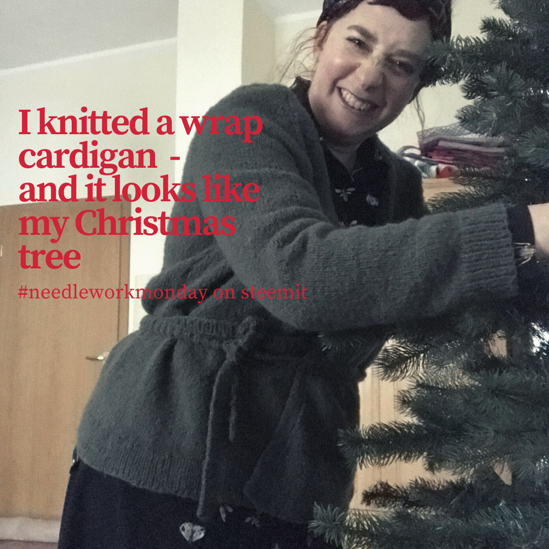 A smiling woman besides a christmas tree with a hand knitted cardigan